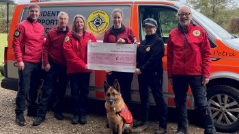 Photo of team members from HSAR Dogs receiving a large cheque from the National Lottery Community Fund